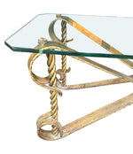 A Spanish 1950s gilt wrought iron coffee table with thick glass top