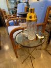 A lovely 1950s Fontana Arte style solid brass tripod martini table with thick glass top